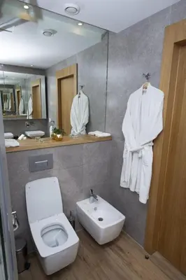 a bathroom with a white toilet and a sink at Appartement raffiné dans un quartier de luxe in Rabat