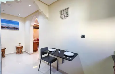 a dining room with a black table and chairs at Classic & Comfy Apartment, Steps to Sea & Tarmway in Rabat