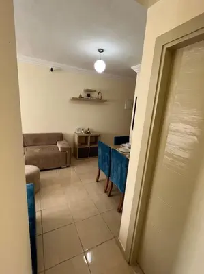 a living room with a table and a couch at Appartement Sidi Rahal in Sidi Rahal