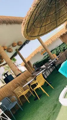 an overhead view of a patio with chairs and an umbrella at Appartement Sidi Rahal in Sidi Rahal