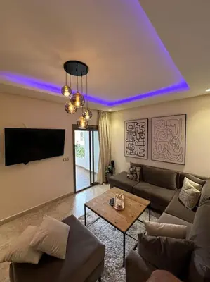 a living room with a couch and a table at Modern apartment centrally located Parc Beach in Mohammedia