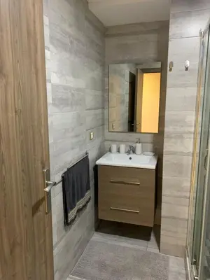 a bathroom with a sink and a mirror at Modern apartment centrally located Parc Beach in Mohammedia