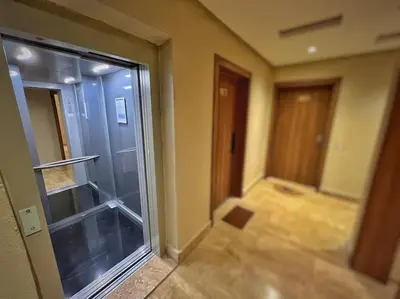 an empty room with a glass door and a hallway at Séjour Chic - Appartement Moderne avec Piscine in Bouznika
