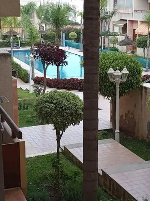 a courtyard with a swimming pool and a street light at Sun Palace Palage des Sablettes D5 in Mohammedia