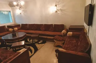 a living room with a couch and a table at Sun Palace Palage des Sablettes D5 in Mohammedia
