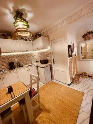 a kitchen with a table and a dining room at Enchanting Studio in Casablanca in Casablanca
