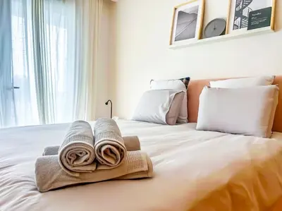 a bed with towels sitting on top of it at Appartement prestige vue dégagée in Casablanca