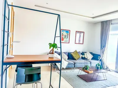 a living room with a blue couch and a table at Appartement prestige vue dégagée in Casablanca