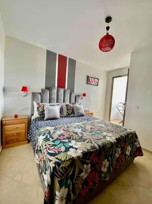 a bedroom with a large bed with a colorful bedspread at Sweet Home in Casablanca