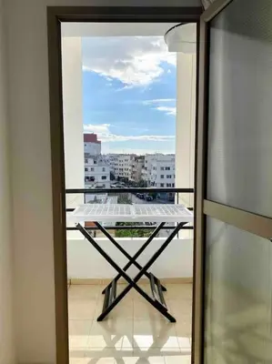 a table on a balcony with a view of a city at Sweet Home in Casablanca