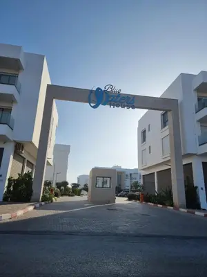 an archway in the middle of a parking lot at Appartement - Dar Bouazza in Dar Bouazza