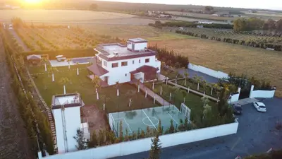 an aerial view of a large white house with a yard at Bens White House in AÃ¯n el Ksob