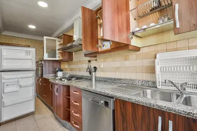 a kitchen with a sink and a refrigerator at Spacious 2 Bed Flat with City Views and Free Parking in Casablanca