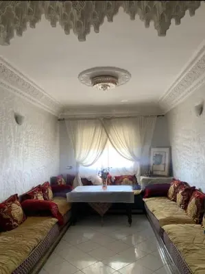 a living room with two couches and a table at Adorable Apartamento a 8 Min del Aeropuerto de Casablanca,WiFi Ultra Rapido y Parking Gratis in Derroua