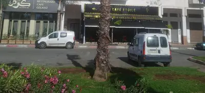 two cars parked in a parking lot in front of a building at Adorable Apartamento a 8 Min del Aeropuerto de Casablanca,WiFi Ultra Rapido y Parking Gratis in Derroua