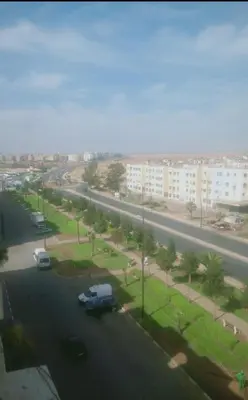 a street with cars parked in a parking lot at Adorable Apartamento a 8 Min del Aeropuerto de Casablanca,WiFi Ultra Rapido y Parking Gratis in Derroua