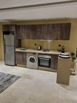a kitchen with a refrigerator and a stove top oven at charmant studio en plein cœur de maarif in Casablanca