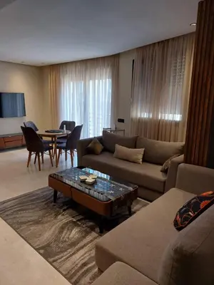 a living room with a couch and a table at charmant studio en plein cœur de maarif in Casablanca