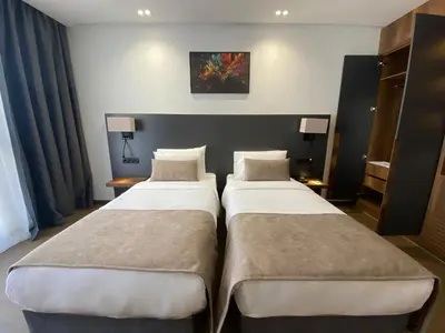 two beds in a hotel room next to each other at Executive Boutique Hotel Rabat in Rabat
