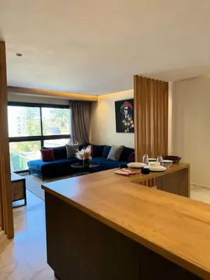 a living room with a blue couch and a table at Classy presidential apartment in Casablanca