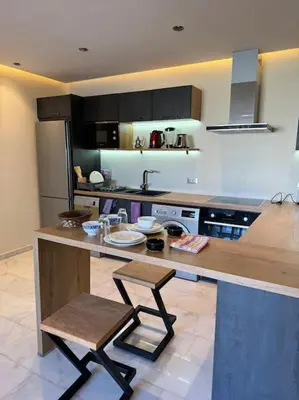 a kitchen with a counter and a chair in it at Classy presidential apartment in Casablanca