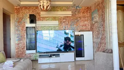 a living room with a flat screen tv on a wall at Confort repos et belle vue mer in Bouznika