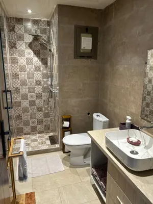 a bathroom with a toilet and a shower and a sink at Appartement haut standing près de la Plage in Skhirat