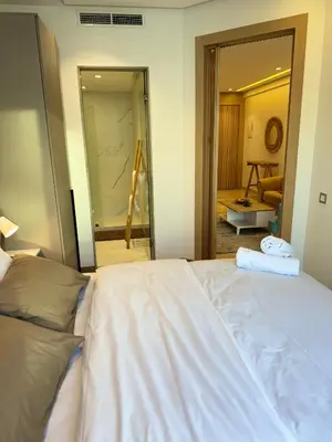 a bedroom with a white bed and a mirror at Presidential living princess in Casablanca