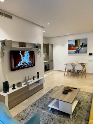a living room with a tv on a wall at Presidential living princess in Casablanca