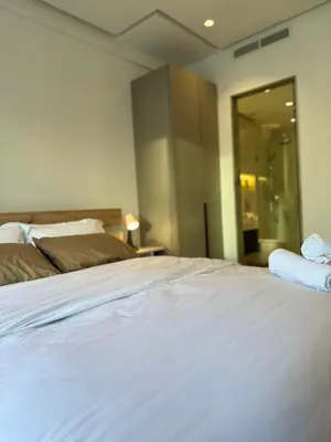 a bedroom with a white bed and a glass door at Presidential living princess in Casablanca