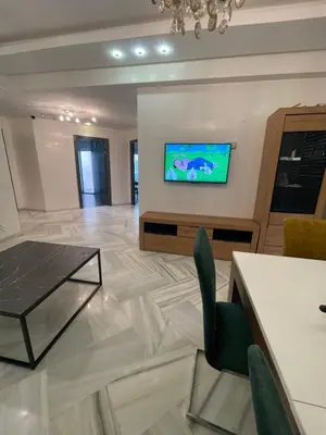 a living room with a television on a wall at La siesta beach resort two bedroom appartement in Mohammedia