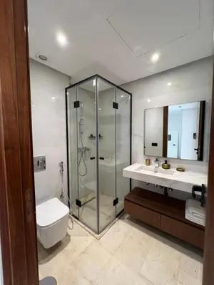 a bathroom with a shower and a toilet and a sink at Duplex One Hill Ville Verte in Casablanca