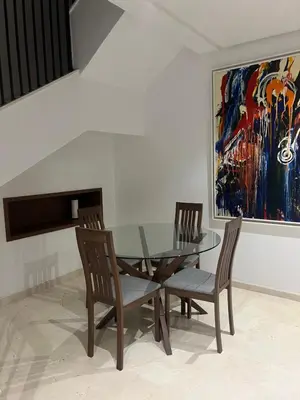 a dining room with a glass table and two chairs at Duplex One Hill Ville Verte in Casablanca