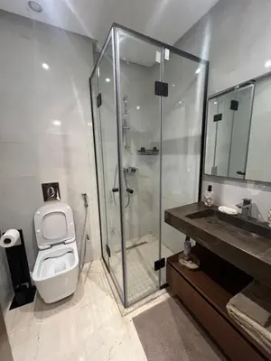 a bathroom with a shower and a toilet and a sink at Duplex One Hill Ville Verte in Casablanca