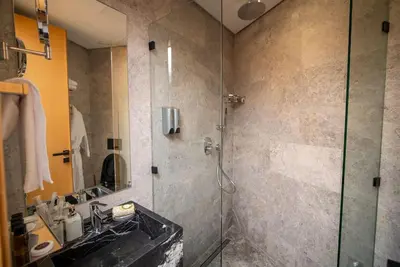 a bathroom with a glass shower and a sink at Le studio in Casablanca
