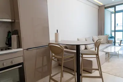 a kitchen and dining room with a table and chairs at Magnifique Studio neuf in Casablanca