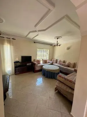 a living room with a couch and a table at Triplex à 5 min de la plage ! in Temara