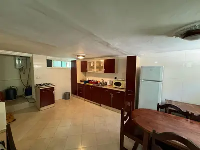 a large kitchen with a table and a refrigerator at Triplex à 5 min de la plage ! in Temara