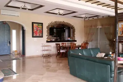 a living room with a couch and a table at Villa, piscine sans vis-à-vis in Casablanca