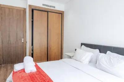 a bedroom with a bed with a red blanket on it at Cozy princesse living maarif in Casablanca