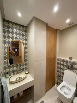 a bathroom with a toilet and a sink and a mirror at La Belle Vue Cosy Apartment in Casablanca