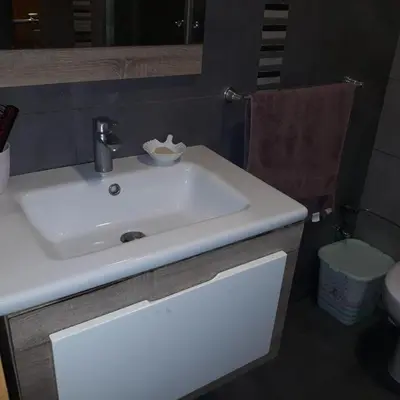 a bathroom with a white sink and a toilet at Appartement Sidi Rahal in Berrechid