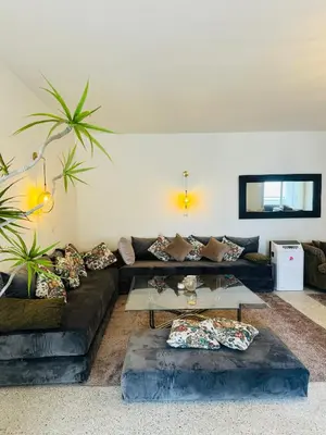 a living room with a couch and a glass table at Appartement spacieux - BD Anfa in Casablanca