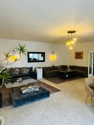 a living room with couches and a table at Appartement spacieux - BD Anfa in Casablanca