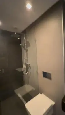a bathroom with a shower and a white toilet at Jasmine's house in Casablanca