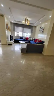 a large living room with a couch and a table at Cité Marine in Mansouria