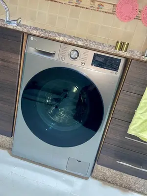 a washing machine is sitting in a kitchen at The hidden oasis, steps from the beach and pool in Mohammedia