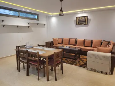 a living room with a table and a couch at Charmante villa vue sur la mer in Tamaris