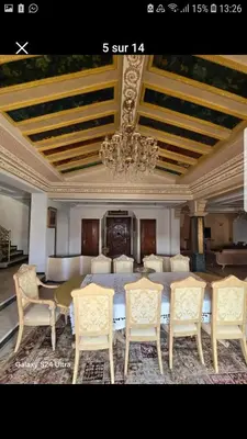 a dining room with a table and chairs and a chandelier at Villa de vacances à Hay Riad in Rabat