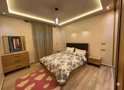 a bedroom with a bed and a dresser at Residence Luxueuse avec 2 Piscines à Harhoura Temara proximité plages princesses & Sables d'Or in El Harhoura